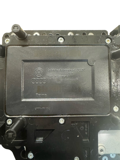 02E927770AE DSG DQ250 mechatronics top label view showing Volkswagen Group logo, Audi rings logo, Getriebe label DQ250, Made in Germany, TEMIC manufacturer marking, and hydraulic connector ports