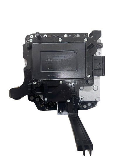 02E927770AE Complete DSG-6 DQ250 mechatronics bottom view showing control unit housing with Audi logo and VW logo, TEMIC manufacturer marking, electrical connectors, hydraulic valve body mounting surface, and Made in Germany label