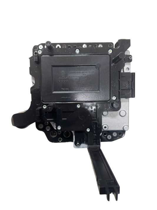 02E927770AE Complete DSG-6 DQ250 mechatronics bottom view showing control unit housing with Audi logo and VW logo, TEMIC manufacturer marking, electrical connectors, hydraulic valve body mounting surface, and Made in Germany label