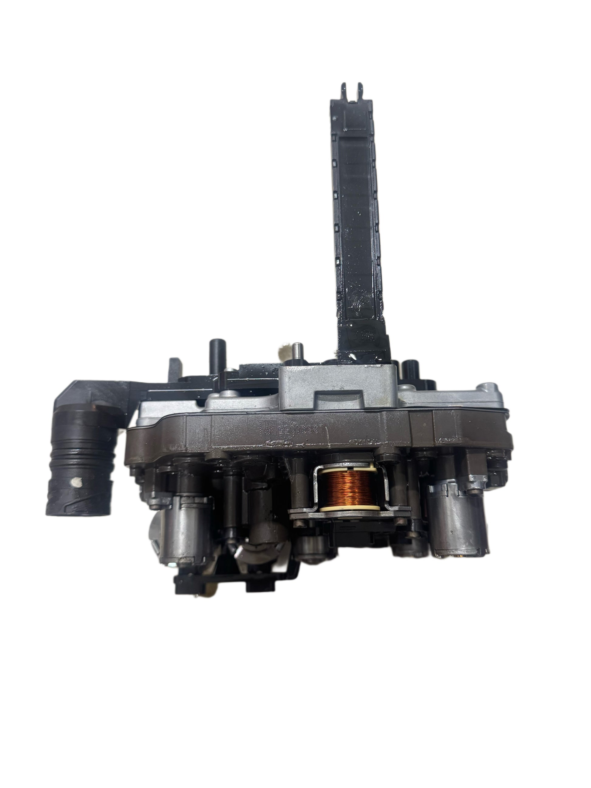 Complete DSG DQ250 mechatronics side profile showing valve body assembly with copper coil solenoid and hydraulic connections